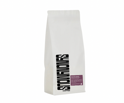 White coffee bag with black text on a white background